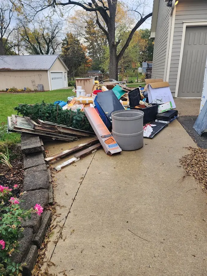 Dumpster being loaded with debris for Estate Cleanout Dumpster Rental in Norfolk